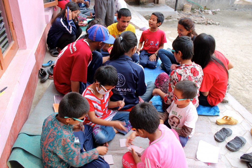 Children at Chhahari children's home in Kathmandu, play spirited rounds of the card game Uno a week after the April 24 "Great Earthquake" struck Nepal. Photo by Cathleen Falsani. 