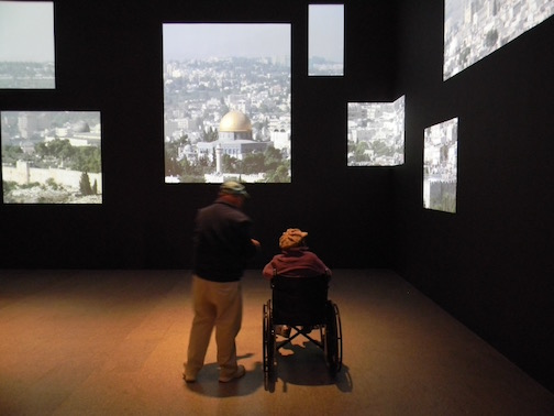 The show opens with images of the famous rooftops of present-day Jerusalem projected on the gallery walls.