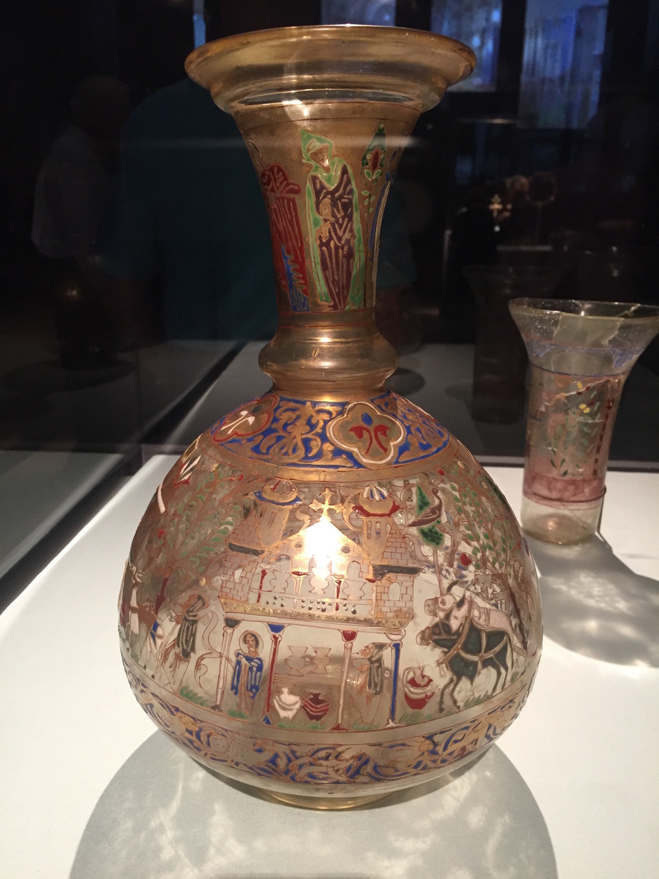 A Christian-themed vase with painted enamel agricultural scenes.