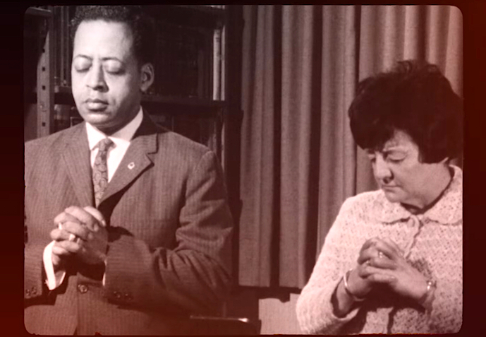 Black and white image of Betty and Barney Hill side by side with hands clasped.