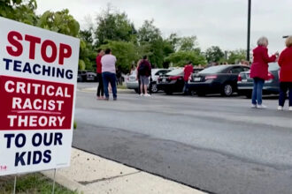 Neighborhood sign reads: Stop Teaching Critical Race Theory To Our Kids.