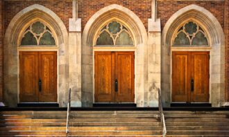 Three church doors in a row, all shut.