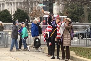Protesters in Washington DC, the day before the January 6 insurrection, wrapped in American flags blow shofars.