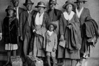 "Scott and Violet Arthur arrive with their family at Chicago's Polk Street Depot on Aug. 30, 1920, two months after their two sons were lynched in Paris, Texas. The picture has become an iconic symbol of the Great Migration. (Chicago History Museum)"