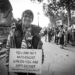 Anti-Zionist Jewish Protestor holds sign "you are not antiracist unless you are anti-zionist"