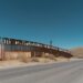 US/Mexican border wall painted with American flag, "no 45" and Klansman